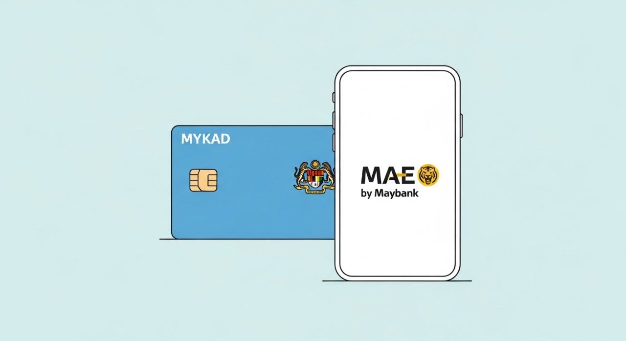 Kad pengenalan Malaysia (MyKad) diletakkan di sebelah telefon pintar yang menunjukkan logo Maybank.